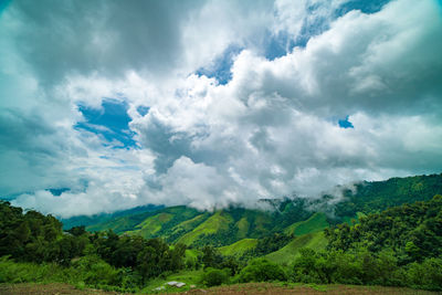 Scenic view of mountain against cloudy sky