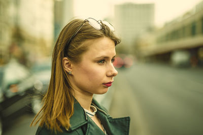 Close-up of thoughtful young woman on street
