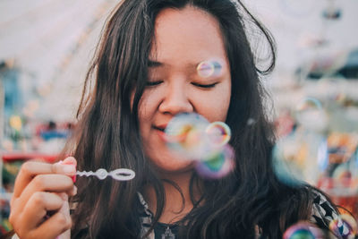 Close-up of woman holding bubble wand 