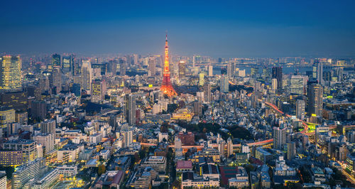 Tokyo tower against sky in city at night