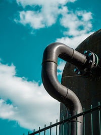 Low angle view of pipe against sky