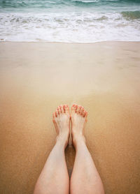 Low section of legs on beach