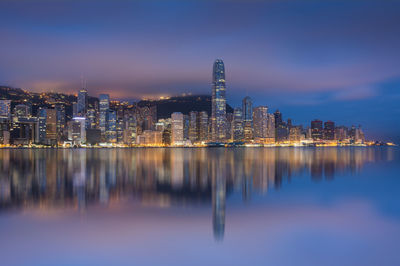 Reflection of illuminated buildings in city at night