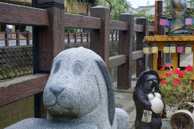 Portrait of dog by statue