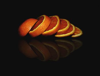 Close-up of orange over black background