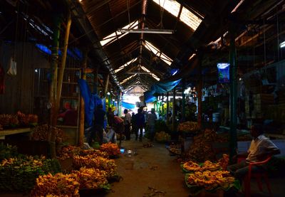 People at market stall at night