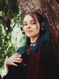 Close-up of smiling hipster listening music on headphones