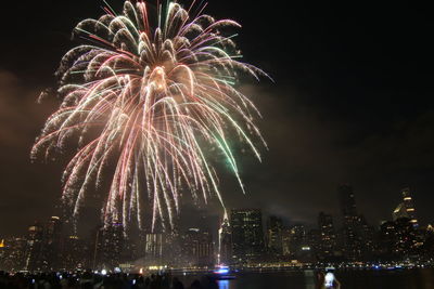 Low angle view of firework display at night