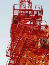 Low angle view of crane against sky