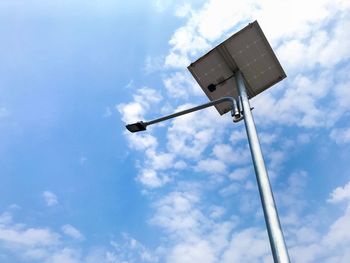 Low angle view of telephone pole against blue sky