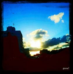 Low angle view of silhouette buildings against sky during sunset