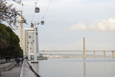 Bridge over sea against sky in city
