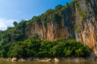 Scenic view of rock formation amidst trees against sky