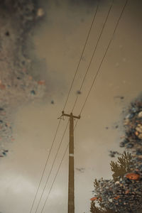 Low angle view of electricity pylon against sky