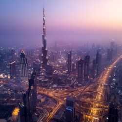 High angle view of city lit up at night