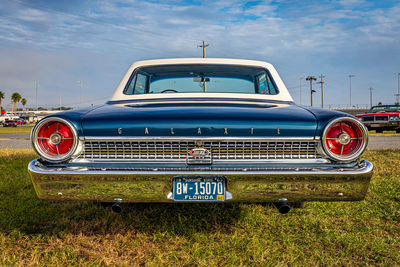 Close-up of vintage car against blue sky