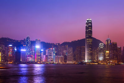 Illuminated buildings against sky at night