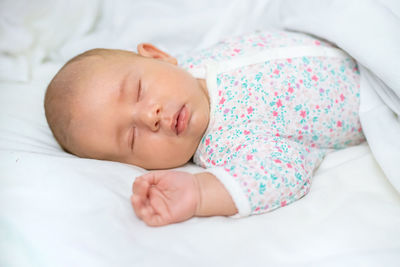 Cute baby sleeping on bed