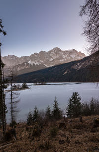 Scenic view of lake and mountains against clear sky