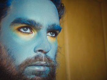 Close-up of serious man with painted face