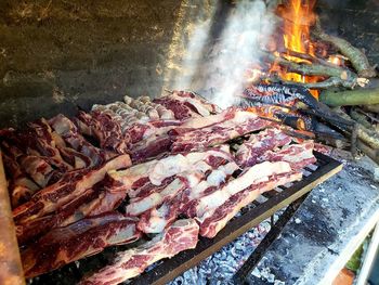 High angle view of meat on barbecue grill