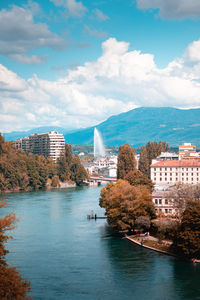 Buildings in city against cloudy sky