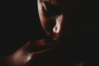 Close-up of man against black background