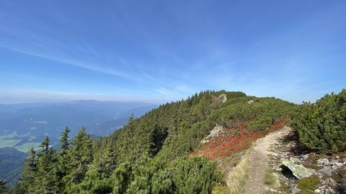 Scenic view of mountains against blue sky