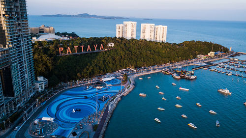 High angle view of buildings by sea against sky