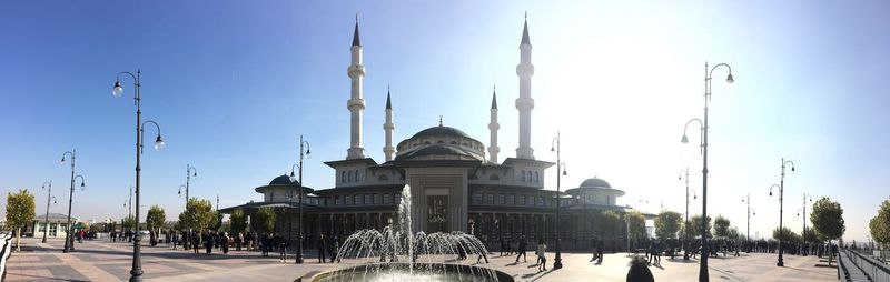 Panoramic view of mosque in city against clear sky