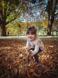 Portrait of girl in autumn leaves