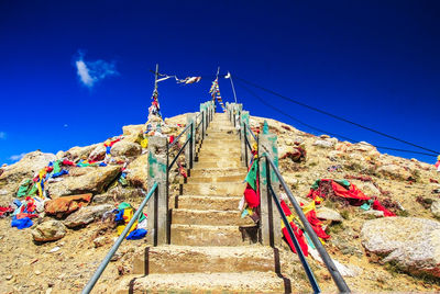 Low angle view of staircase against blue sky