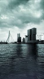 Bridge over river with buildings in background