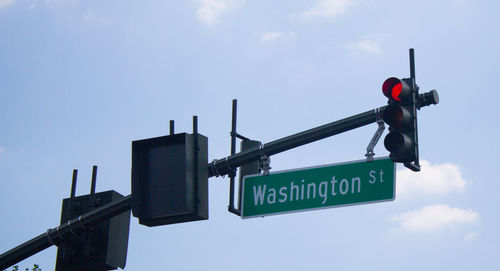 Low angle view of road sign against sky