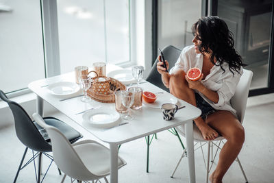 Woman sitting with drink on table