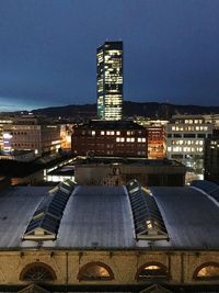 Illuminated cityscape against clear sky at night