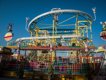 Low angle view of ferris wheel against sky