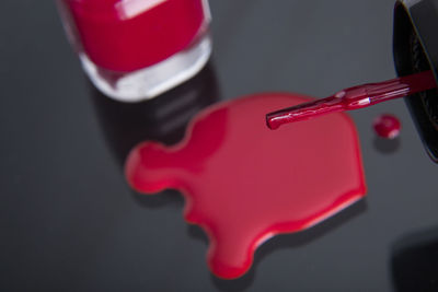 High angle view of red nail paint on table