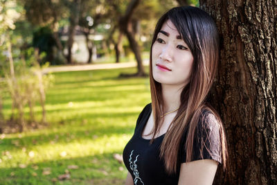 Portrait of young woman in tree