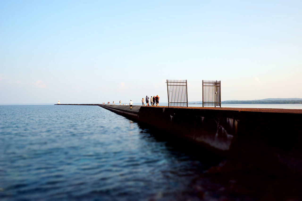 sky, water, sea, horizon, horizon over water, nature, scenics - nature, copy space, beauty in nature, incidental people, real people, built structure, tranquil scene, architecture, outdoors, clear sky, day, tranquility, lifestyles