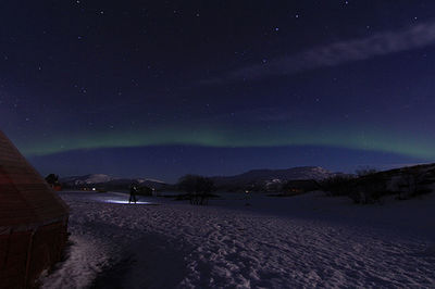 Scenic view of snowcapped mountains against sky at night