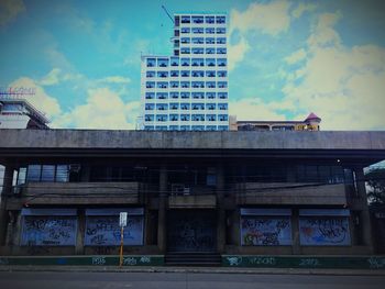 Low angle view of building against cloudy sky