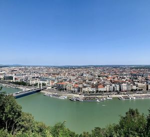 High angle view of city against blue sky