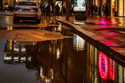 Reflection of cars on street in city at night