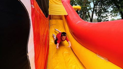 Boy sliding on slide