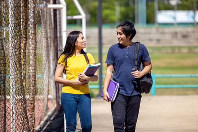 Young woman using smart phone while standing outdoors