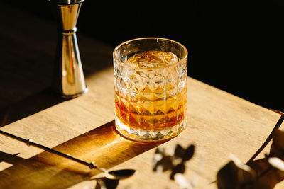 Close-up of glass with bourbon whiskey on table