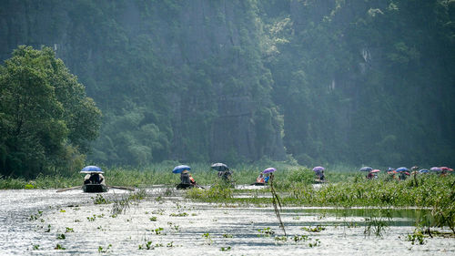 People working on land against clear sky