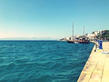 Scenic view of sea against clear blue sky