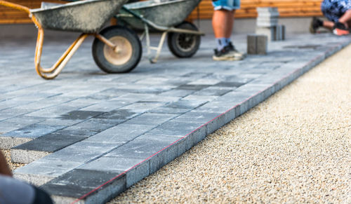 Construction worker standing on paving stones at street